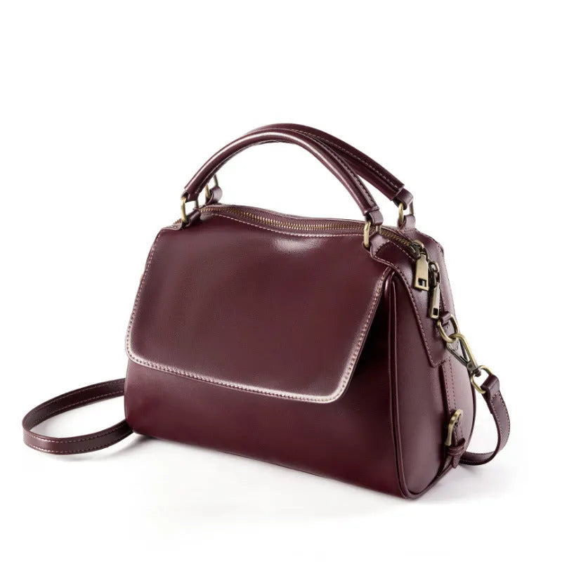 Women's genuine leather crossbody tote bag in apricot colour showing internal compartments and shoulder straps.