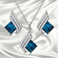 Gold-toned women's necklace and earring set with alloy, glass, and a cross chain, shown in two style options.