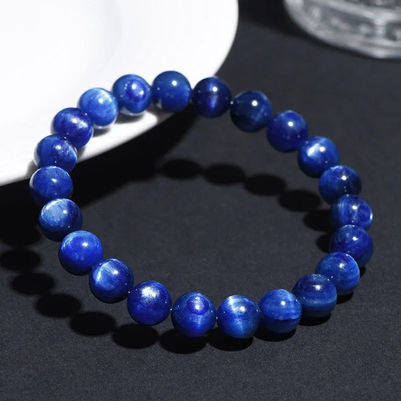 A blue crystal ball bracelet with a geometric shape and traditional Ruyi design elements.