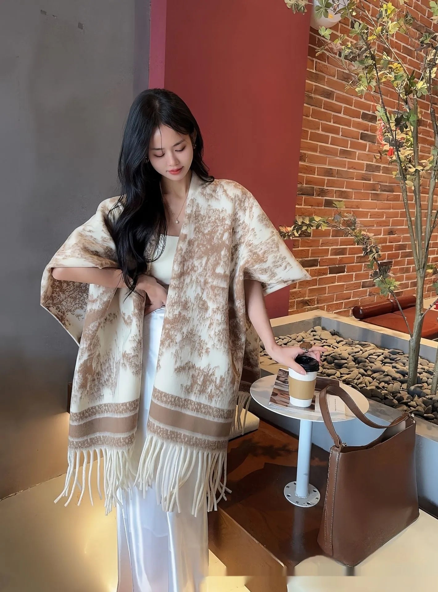 Women's polyester tassel scarf cape draped over shoulders showing fringe detailing