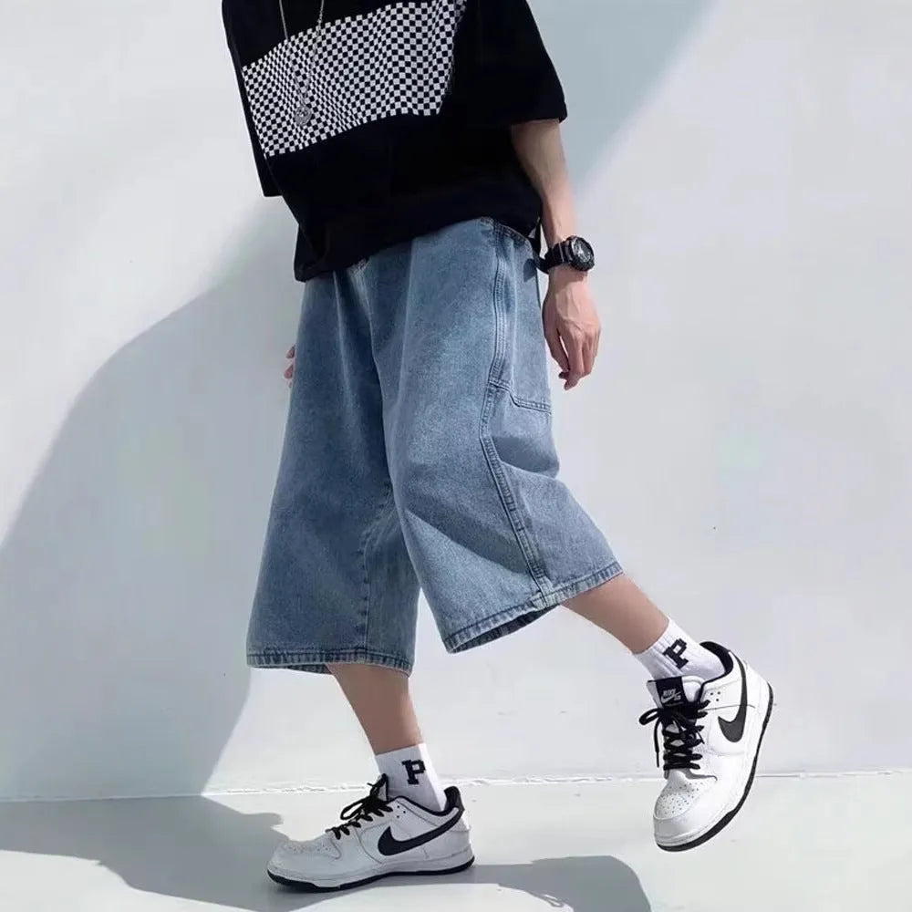 Man wearing blue washed denim pirate-style shorts with cropped length and high waist.
