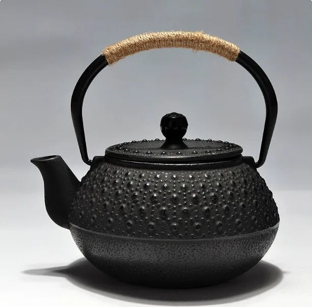 A cast iron teapot with Japanese-style hand-painted decoration, shown in a Bronze finish, with a capacity of 0.9 litres.