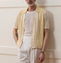 Yellow casual polo shirt with asymmetric hollow-out design and short sleeves.