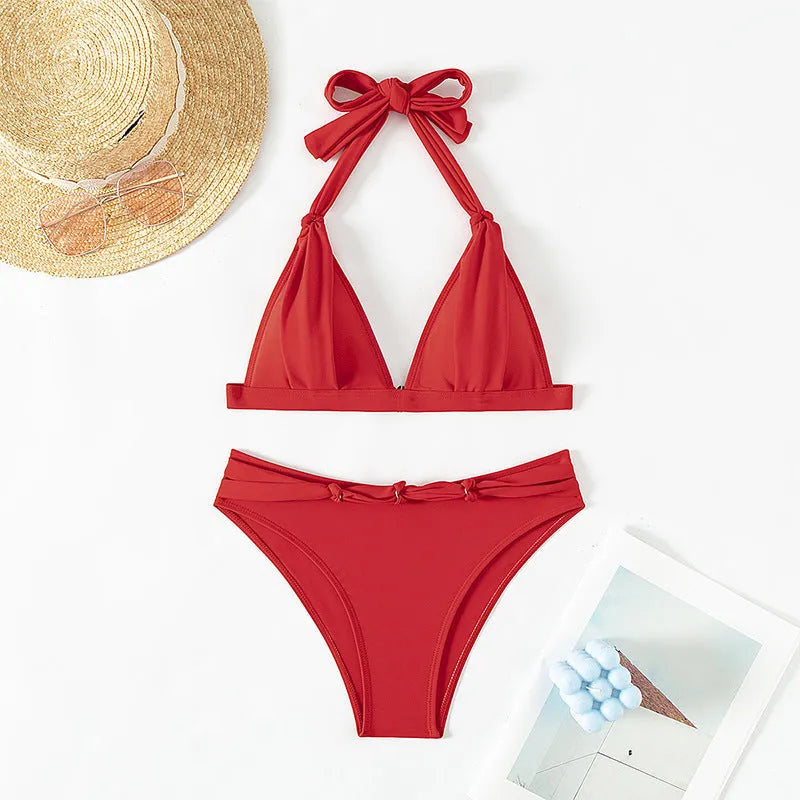 Red women's halterneck bikini set with lace-up front and matching split shorts.
