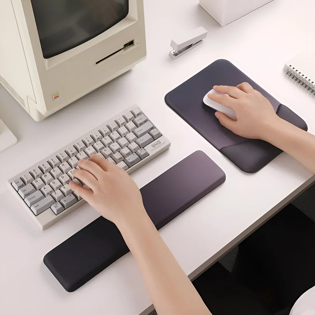 Square black silica gel wrist rest mouse pad on a desk with keyboard