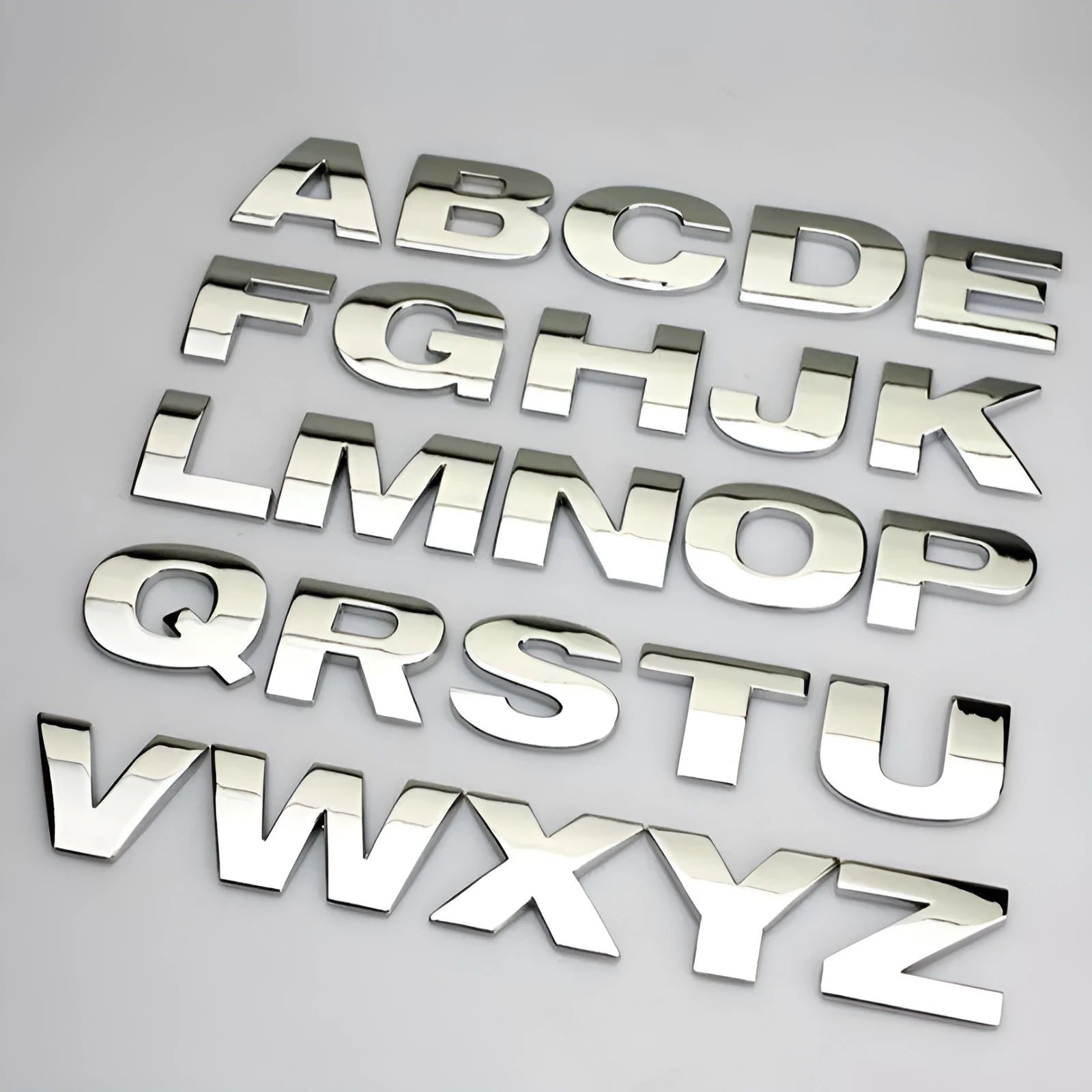 Metal car bumper stickers showing 3D raised English alphabet letters in silver finish
