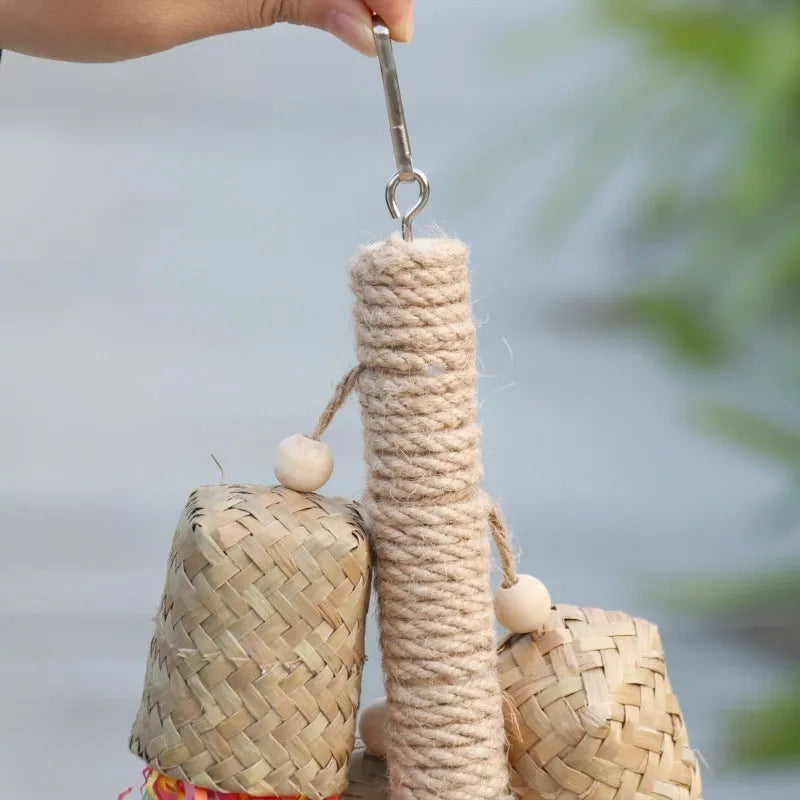 Wooden parrot chew toy with colourful shredded paper hanging from sisal rope