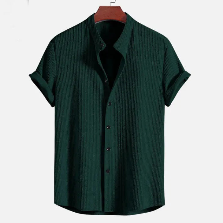 Men's loose fit short sleeve polyester summer shirt on a hanger, shown in a light blue colour.