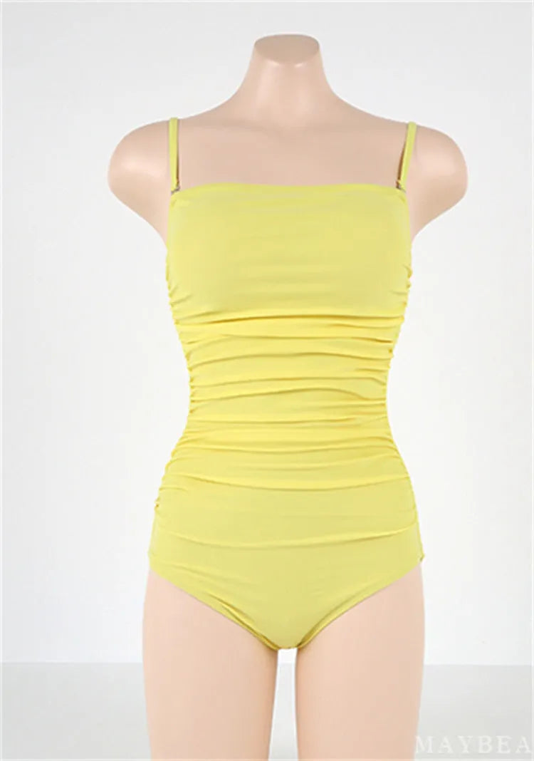 Blue sling style one-piece swimsuit with belly pleats on a mannequin, showing slim-fit design