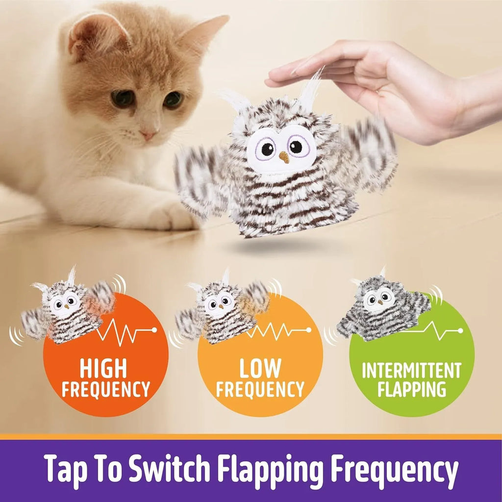 Grey owl-shaped automatic cat toy with flapping wings on charging cable