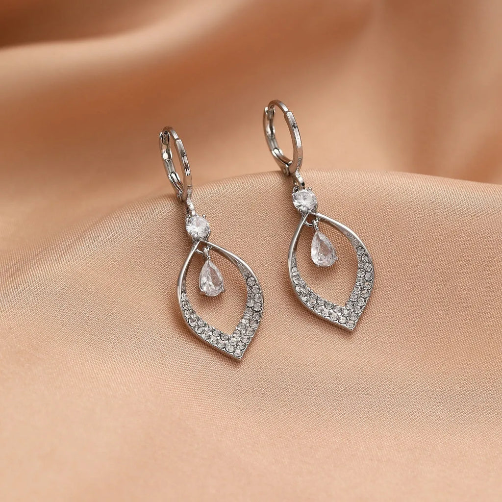 Copper electroplated women's earrings with a teardrop shape, water drop tassels, and zircon stones in gold colour.