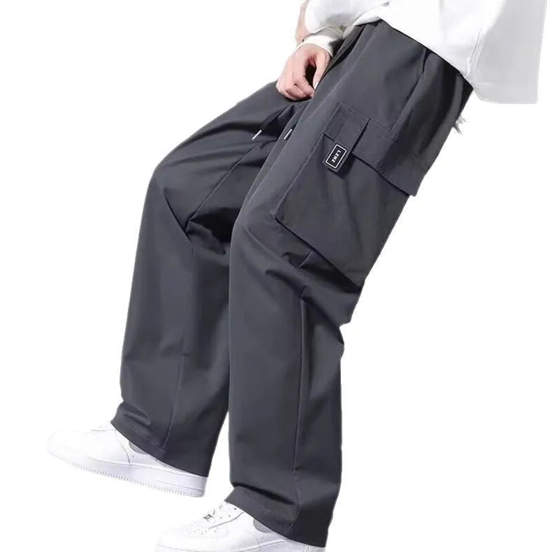 Boys in straight-leg cargo pants with drawstring waist and large side pockets, shown in army green.