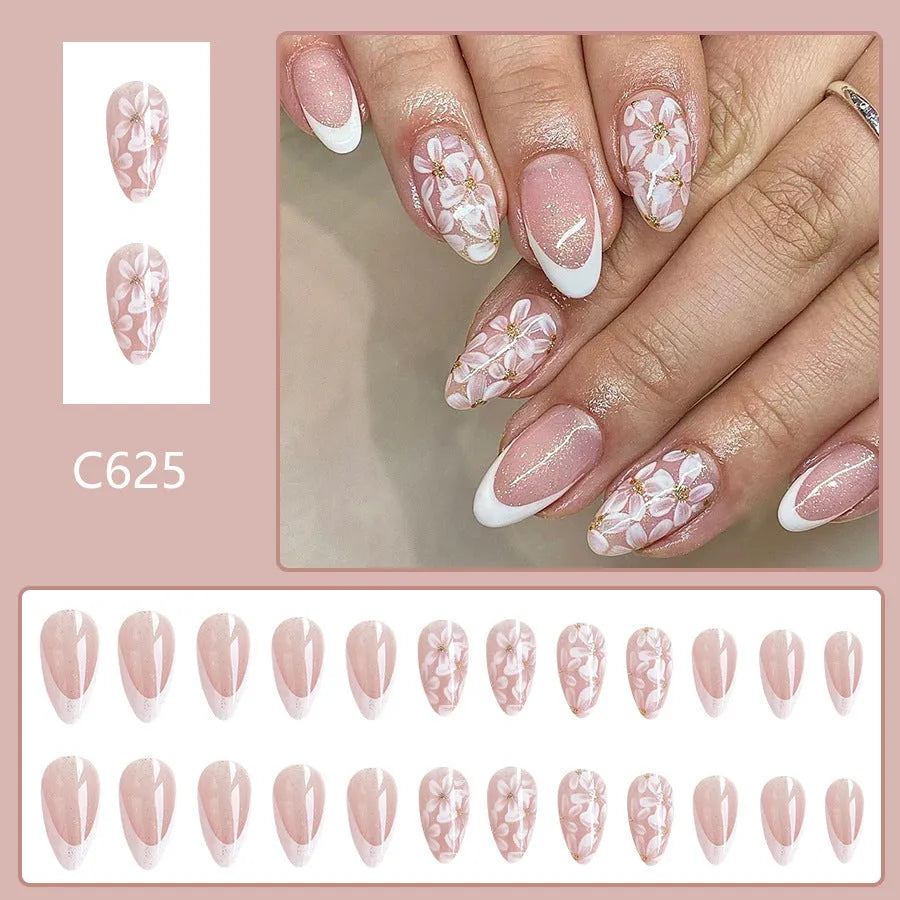 Short almond French style press-on nails with glitter flower decoration in colour C625