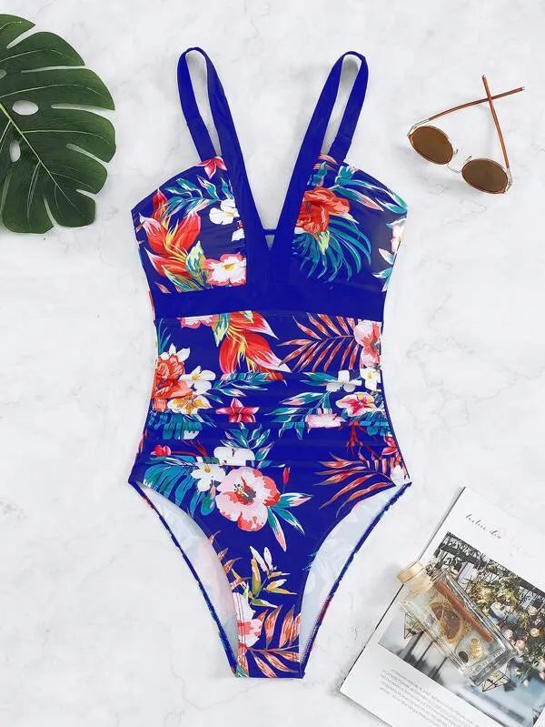 Women's floral patterned, backless one-piece swimsuit on a hanger