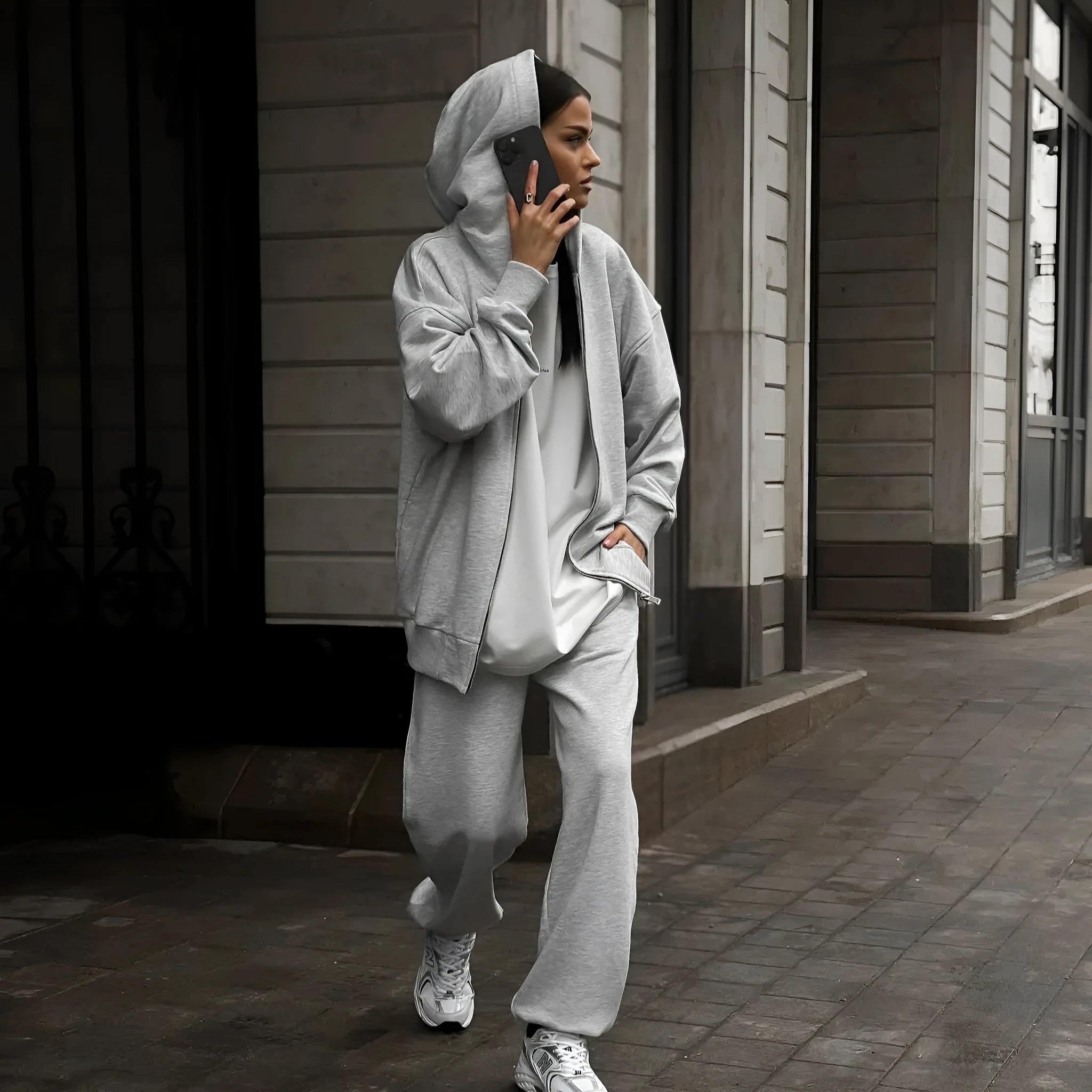 Street style loose-fit two-piece set with long-sleeved coat and trousers in grey.