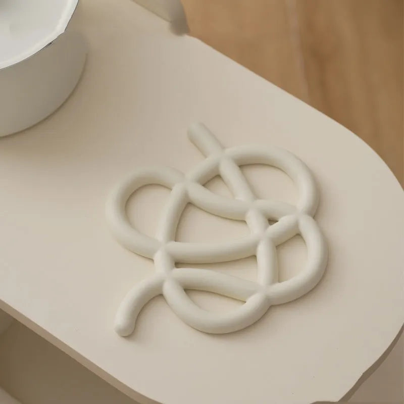 Ceramic heat proof mat in irregular shape on dining table surface
