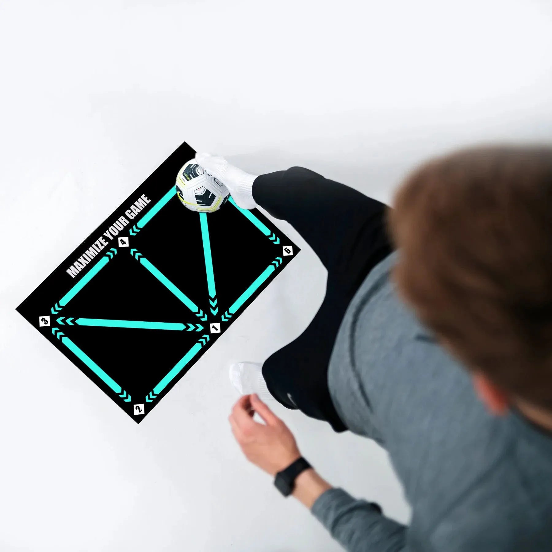 Black 60x90cm football training mat on a flat surface
