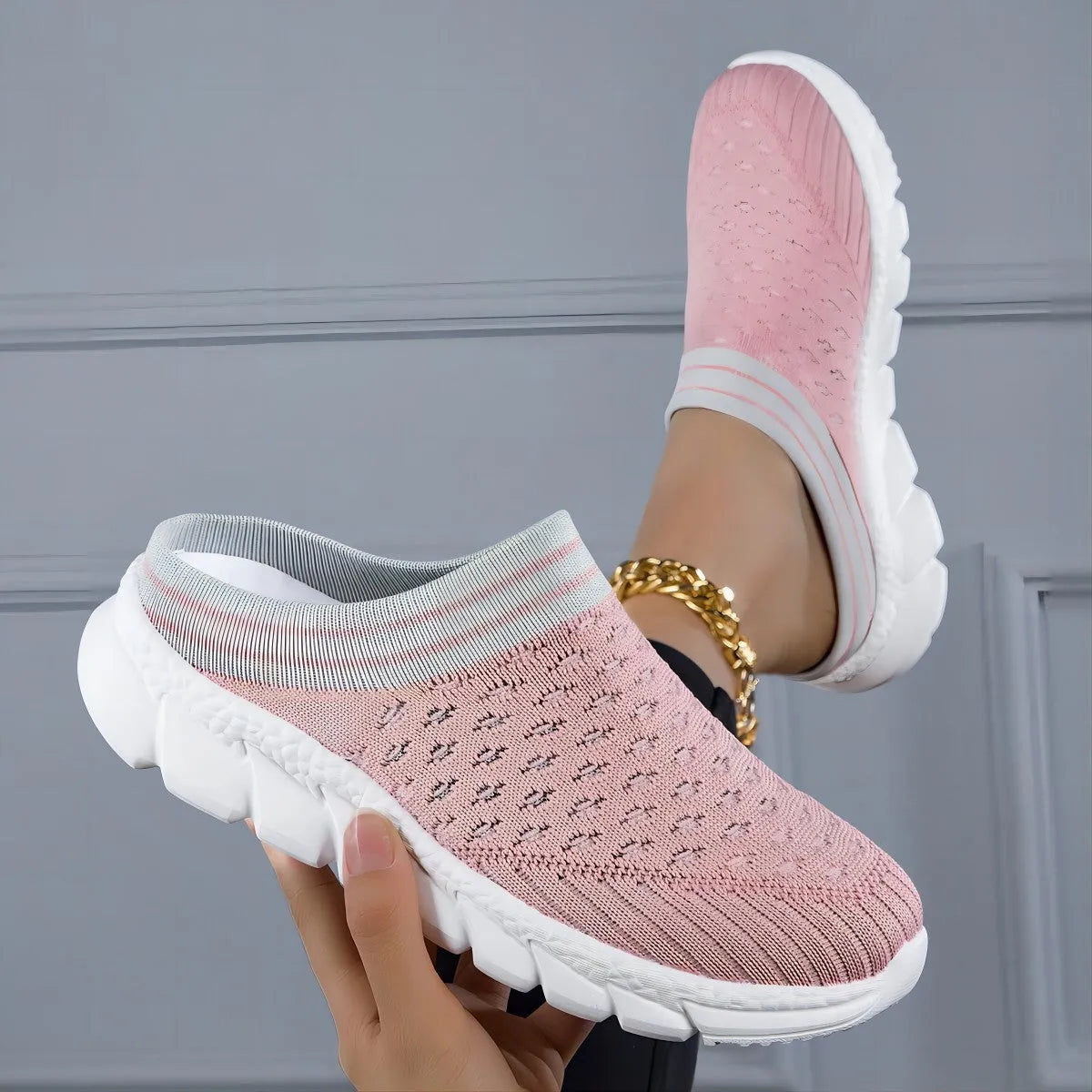 Women's black Flyknit slipper shoes with striped pattern and hollowed-out design on a viscose sole.