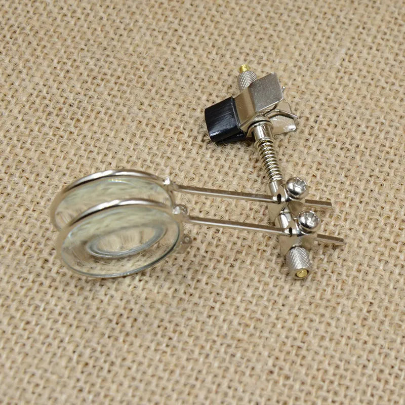 Auxiliary reading glass double clip with metal bracket and glass lenses for clip-on magnification.