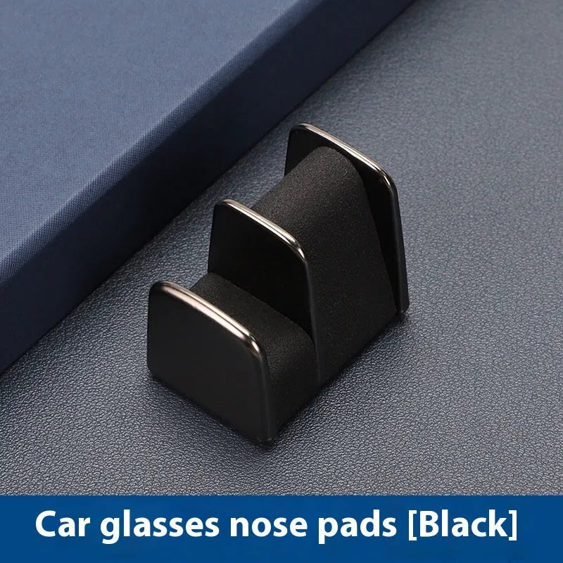 Green zinc alloy and leather glasses clip holder mounted on a car dashboard.
