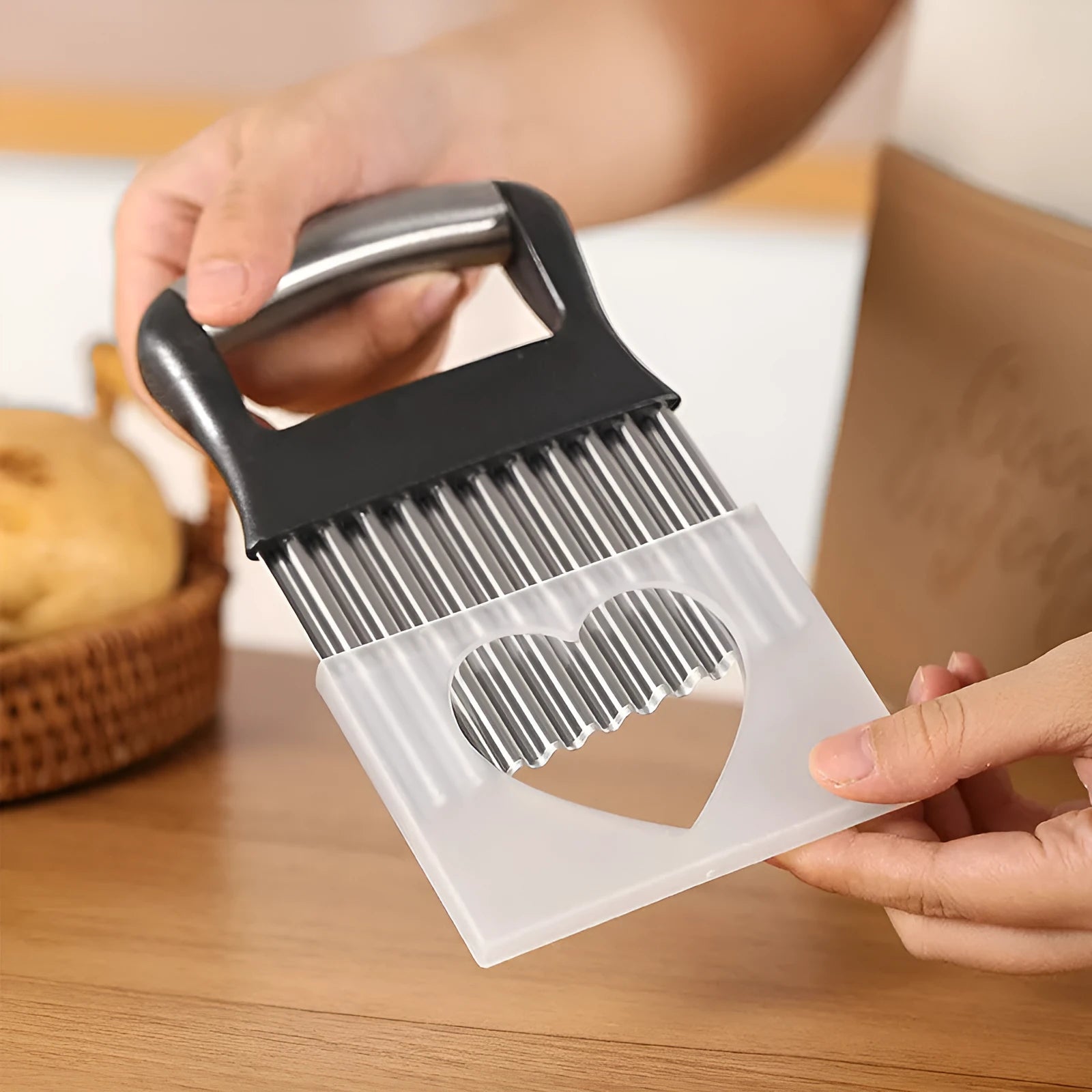 Stainless steel potato wave knife on a kitchen counter, showing its crinkle cut blade and compact 14 cm size.