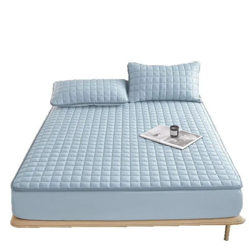 A washed cotton waterproof fitted sheet in a neutral colour, shown fitted neatly on a mattress corner.