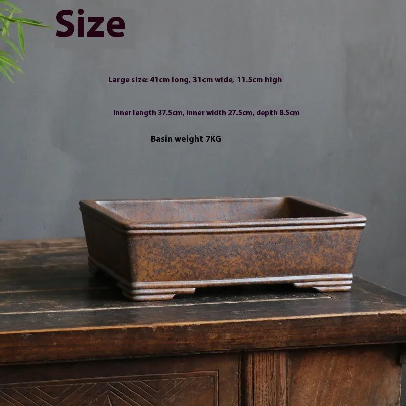 Purple sand rectangular bonsai planter with five-line basin design on wooden surface