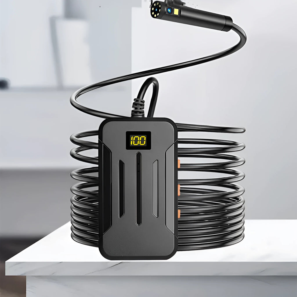 Wireless endoscope with dual-lens camera, magnet, and hook accessories on a table