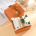 Gold green square women's watch with matching butterfly bracelets on wrist