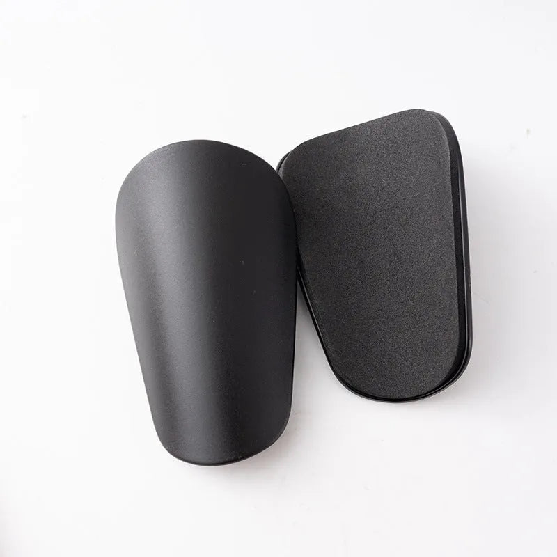 Pair of black PU mini shin guards for sports protection, showing S size.