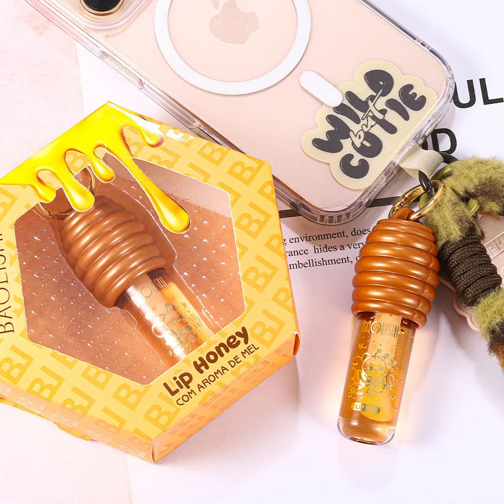 Honey lip gloss in portable keychain container for moisturising lip care