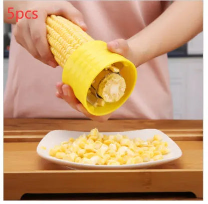 Yellow manual corn grinder thresher with a corn-kernel shaped PP handle and stainless steel peeling gear.