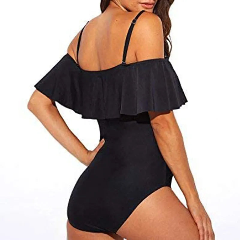 Black one-piece swimsuit with ruffled tube top straps and side cut-out details