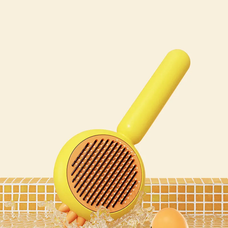 Purple pet grooming brush with stainless steel bristles and cleaning button
