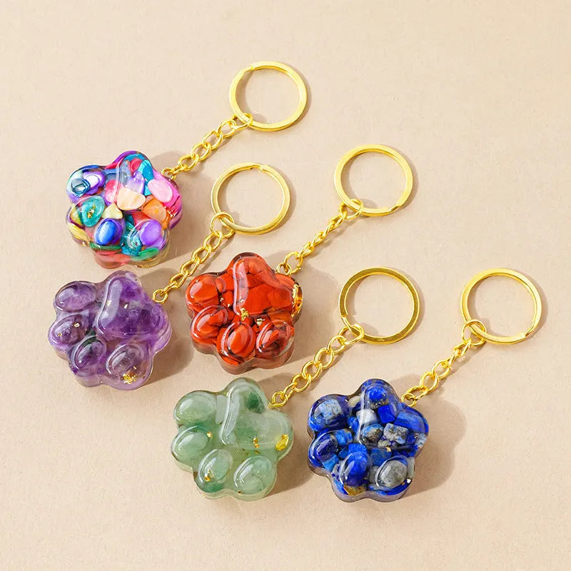 Natural crystal cat's paw keychain pendant in various gemstone colours including pink, red, blue, and green