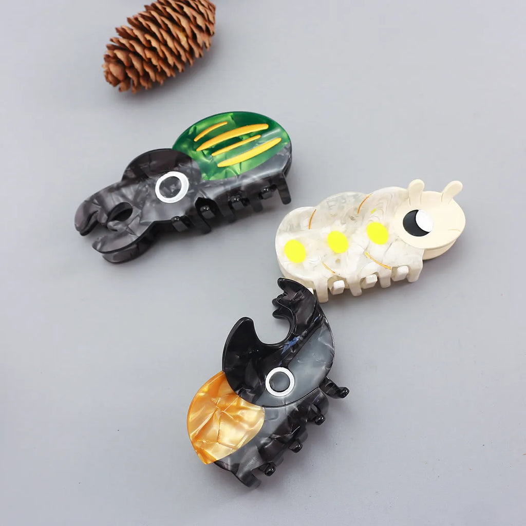Handmade cellulose acetate hair clip with cartoon beetle design in green or orange colour options