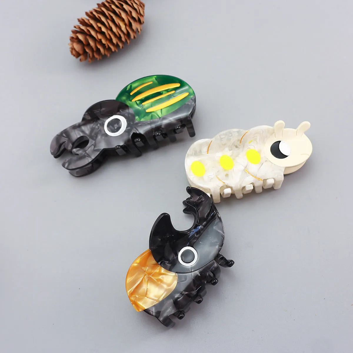 Handmade cellulose acetate hair clip with cartoon beetle design in green or orange colour options