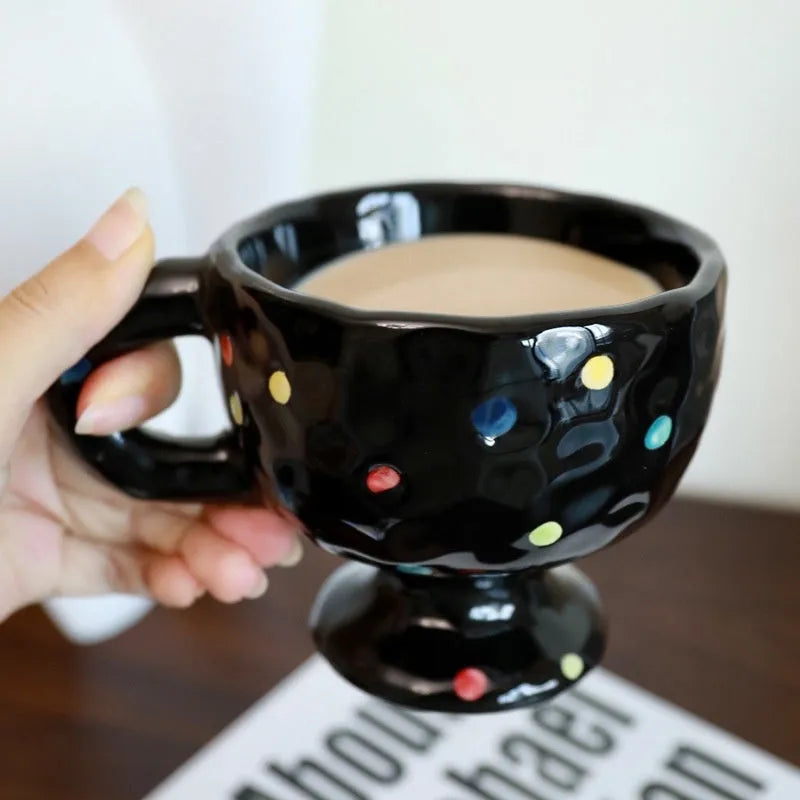 Hand-pinched irregular shaped ceramic mug in a solid colour, shown from the side.
