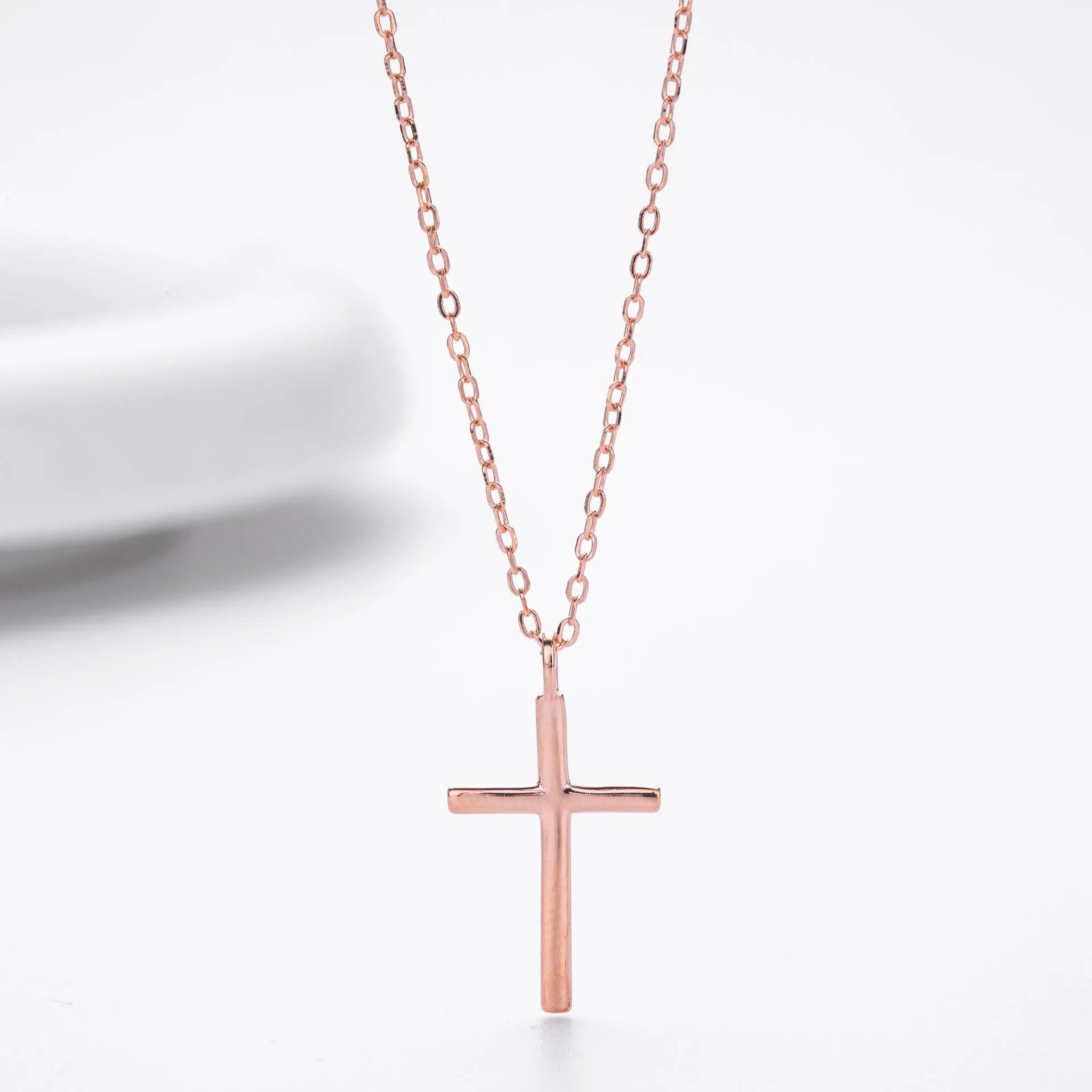 Sterling silver necklace with glossy cross pendant on O-shaped chain, adjustable length