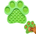 Blue silicone dog licking mat with bone texture and suction cups on a white bathroom tile.
