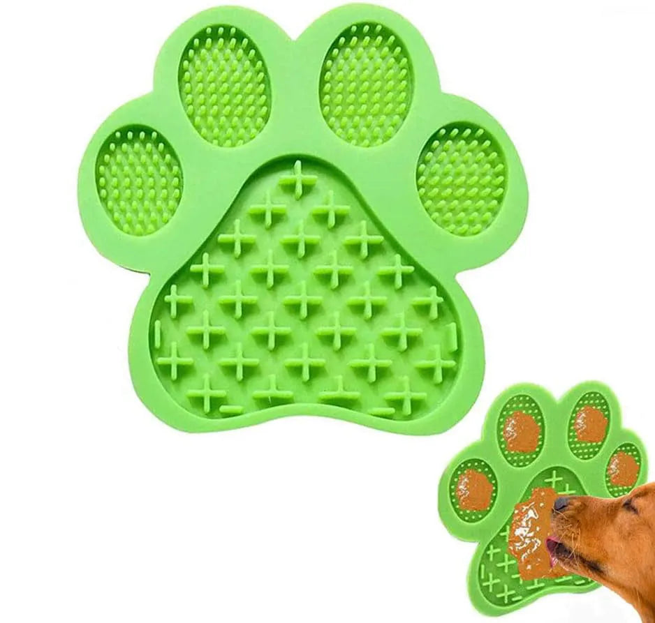 Blue silicone dog licking mat with bone texture and suction cups on a white bathroom tile.