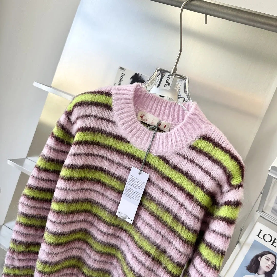 Pink wool lazy coat style cardigan sweater with contrast colour details on a hanger.