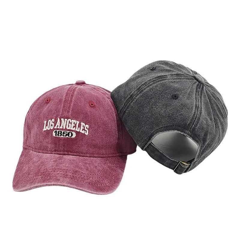 Retro peaked cap with distressed letter embroidery and adjustable sizing in conical crown design