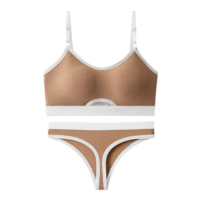 White sports underwear vest with contrast back detail and matching underwear, shown on a hanger.