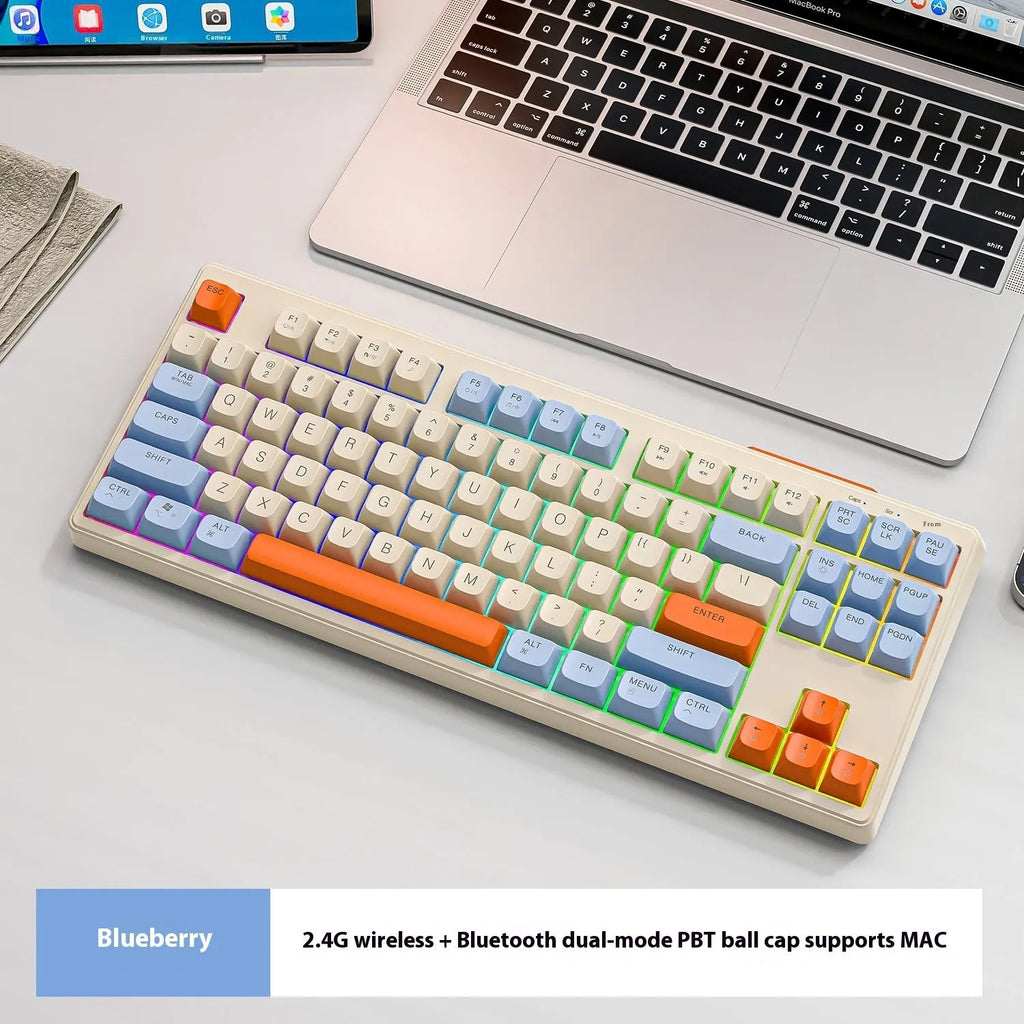 Free Wolf M87 wireless Bluetooth keyboard in blueberry colour on a desk with USB receiver and cable.