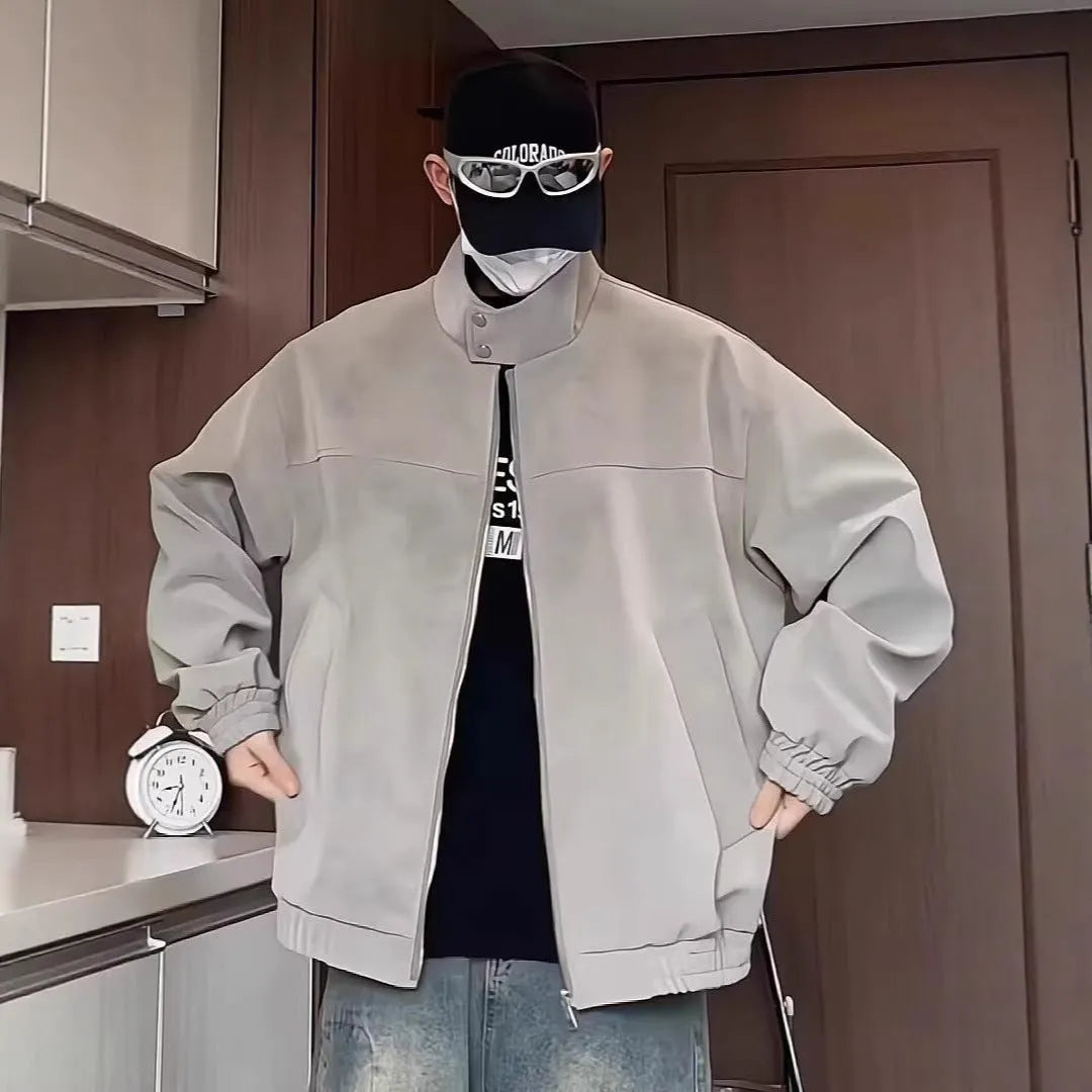 Man wearing a grey tie-dye patterned PU leather jacket with a stand collar and side pockets.