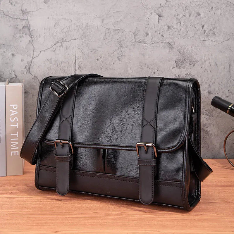 Black Korean style men's anti-theft backpack made from PU leather with visible sewing thread detailing.