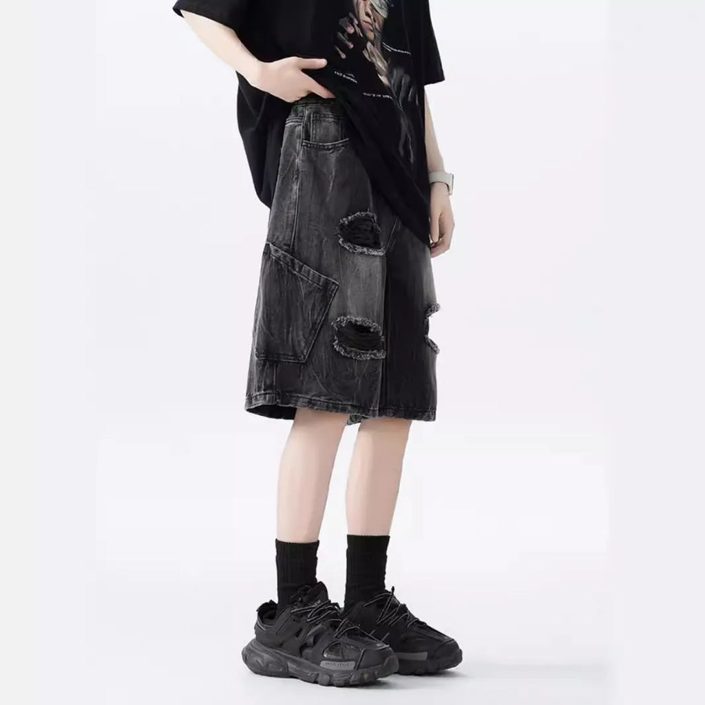 Loose fit ripped denim shorts in black and blue washes on a size chart