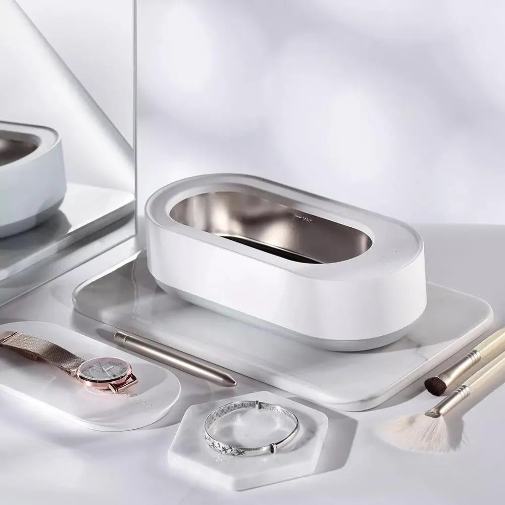White portable ultrasonic cleaner machine with stainless steel tank for cleaning jewellery and glasses.