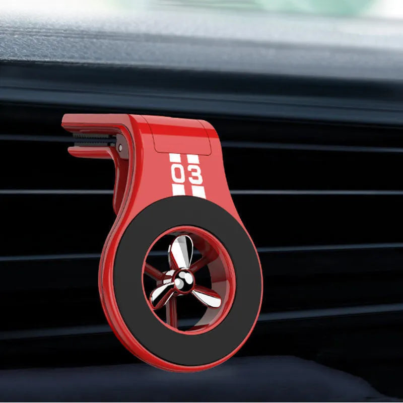 Magnetic car air vent phone holder with perfume dispenser in black, showing phone attached and fragrance slot.